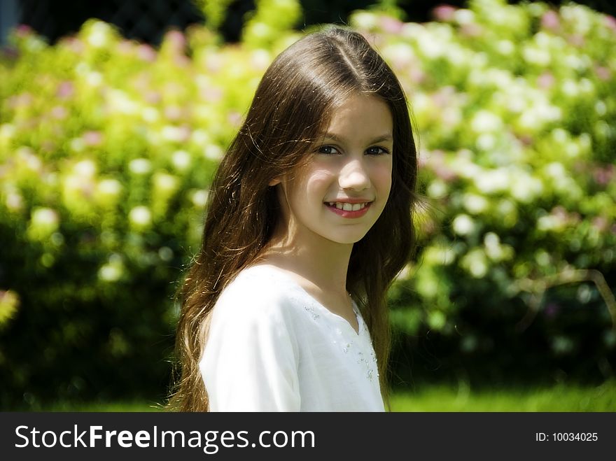 Portrait of pretty girl in garden smile and look at camera. Portrait of pretty girl in garden smile and look at camera