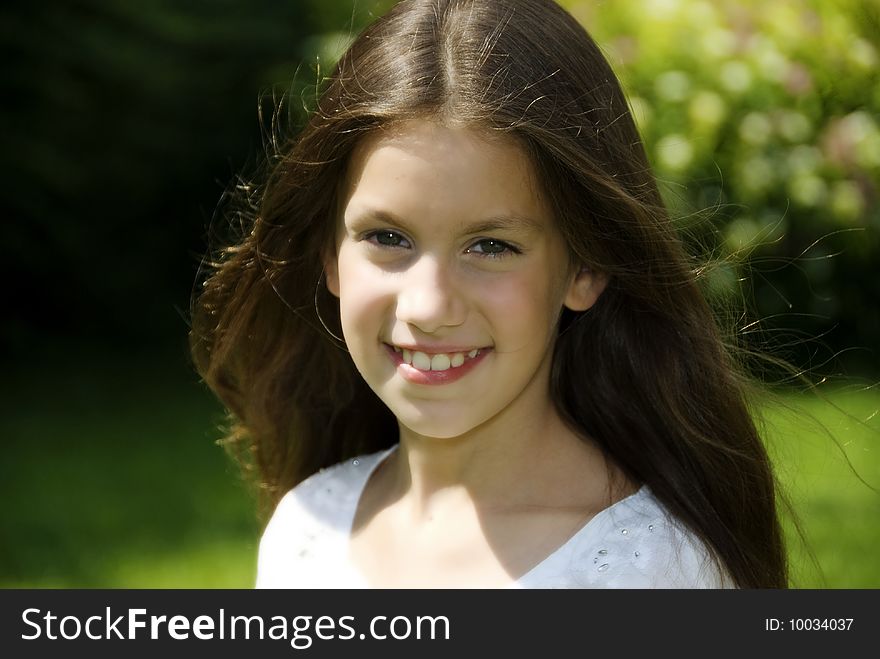 Close up face of pretty girl in garden who looking and smiling to camera. Close up face of pretty girl in garden who looking and smiling to camera
