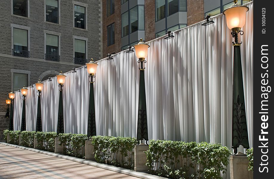 Curtained dividing wall in a commercial complex with light poles