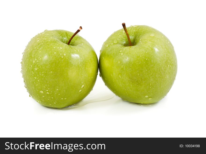 Two green apples with droplets on a white background