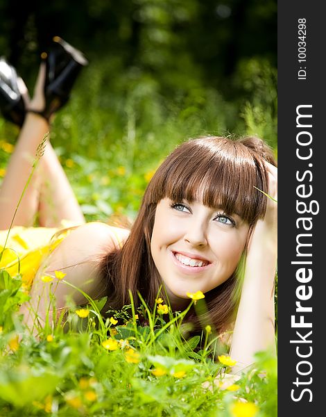 Beauty Young Woman Relaxing In The Grass