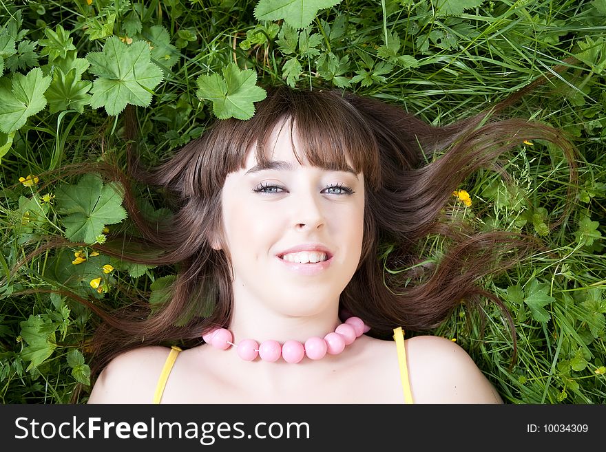 Smiling girl relaxing on the meadow