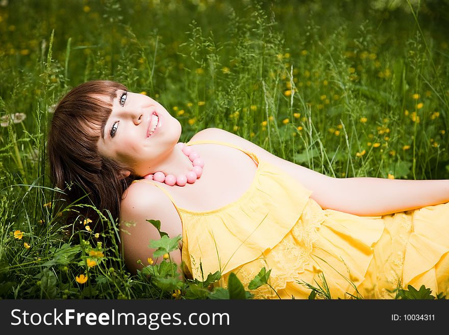 Young beautiful woman lays on green field. Young beautiful woman lays on green field