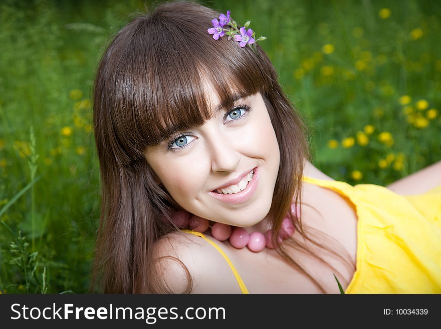 Smiling girl relaxing on the meadow
