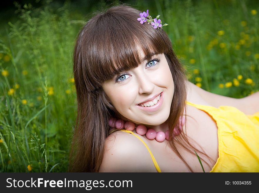 Pretty young smiling girl relaxing outdoor