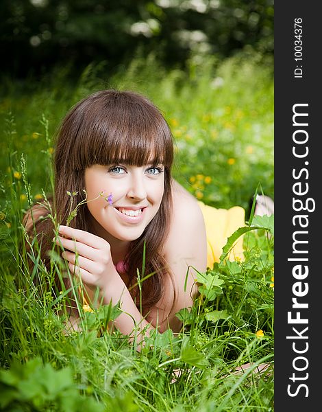 Beauty young woman relaxing in the grass