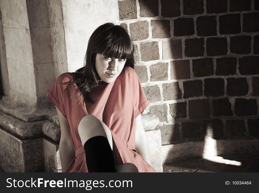 Smiling Woman Against Brick Border