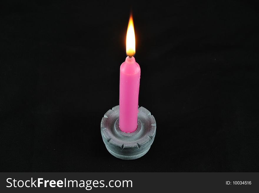 Candle placed over stone holder. Candle placed over stone holder.