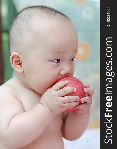 Cute baby boy open his mouth to eat red apple. Cute baby boy open his mouth to eat red apple