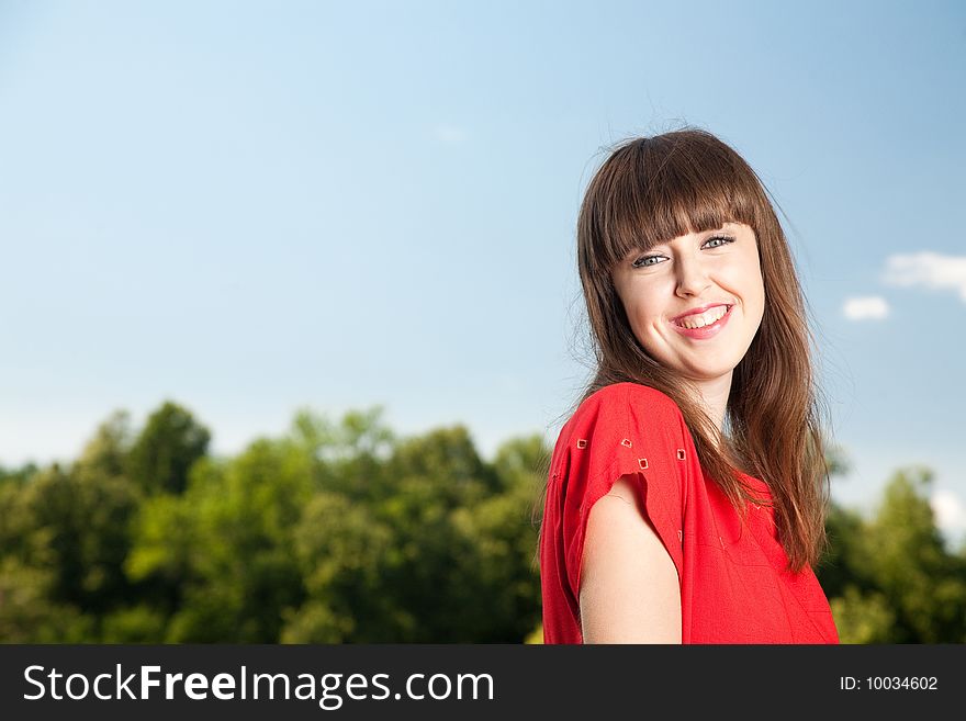 Smiling Beauty Woman Against Blue Sky. Smiling Beauty Woman Against Blue Sky