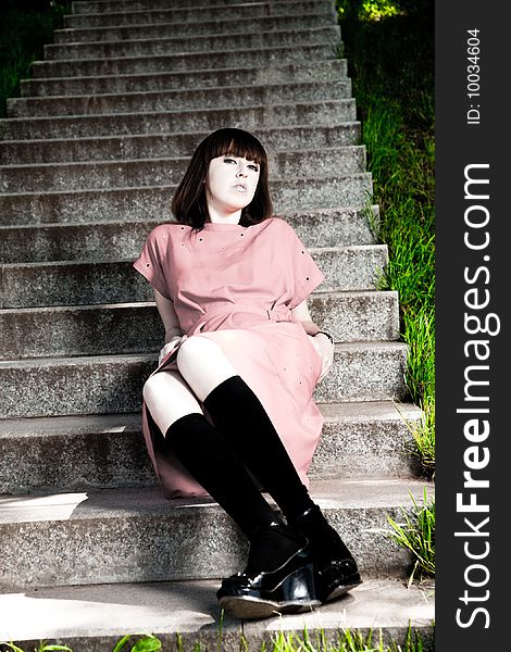 Pretty Young Woman Sitting On A Stone Stairs. Pretty Young Woman Sitting On A Stone Stairs