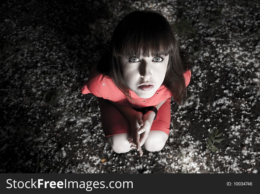 Young Woman Sitting At The Ground