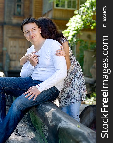 Woman with man sit on a tree to embrace each other. Woman with man sit on a tree to embrace each other