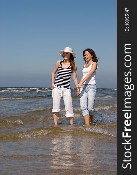 Two girls playing in the sea on a sunny day. Two girls playing in the sea on a sunny day