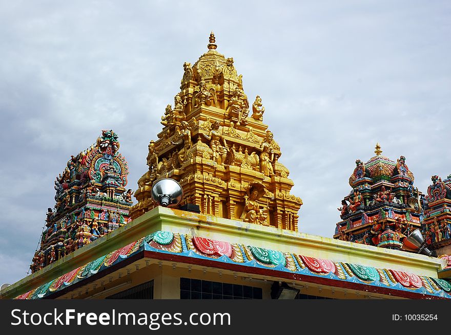 Indian god temple with alot of deities carving on top. Indian god temple with alot of deities carving on top