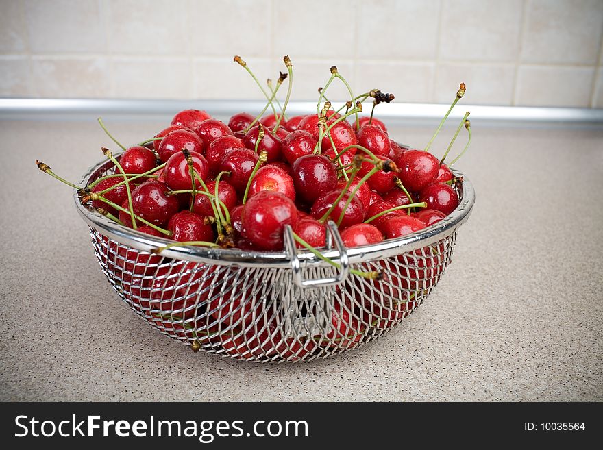 Many wet fresh cherry on the kitchen table. Many wet fresh cherry on the kitchen table