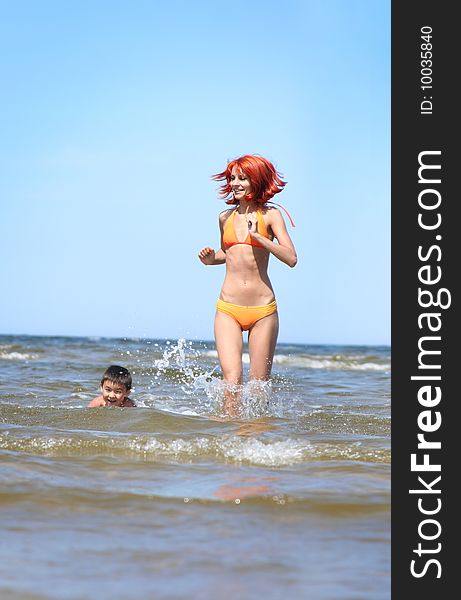 Young mother and son having fun on the beach. Young mother and son having fun on the beach
