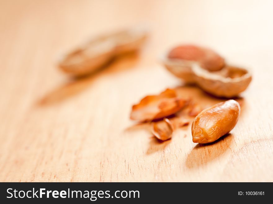 Peanuts on Wood Background with Dramatic Lighting.