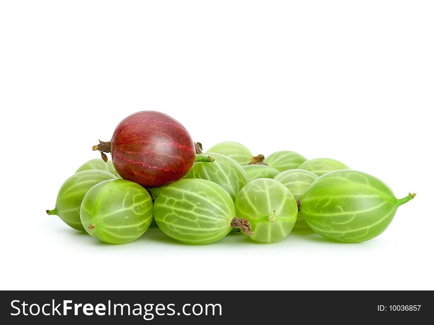 Pile of green gooseberries and purple on the top isolated on the white background