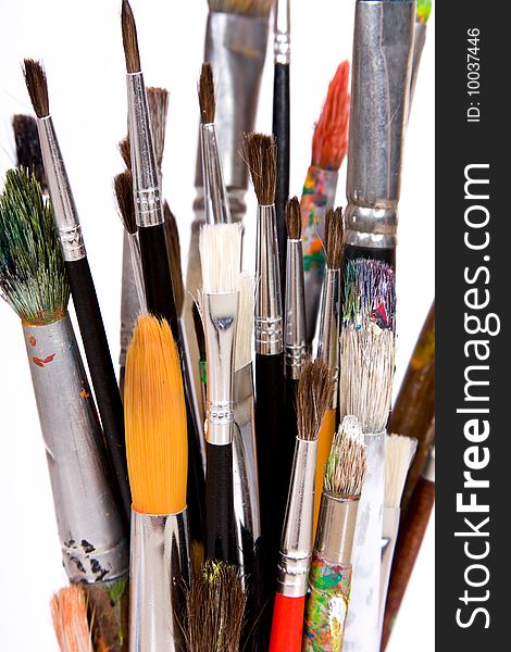 Various colored paintbrush on white background