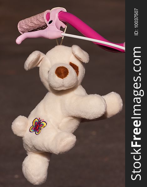 Puppy plush toy hooked on a bike handle. Puppy plush toy hooked on a bike handle