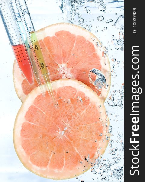 Red grapefruit in water. Creative fruit and bubbles water