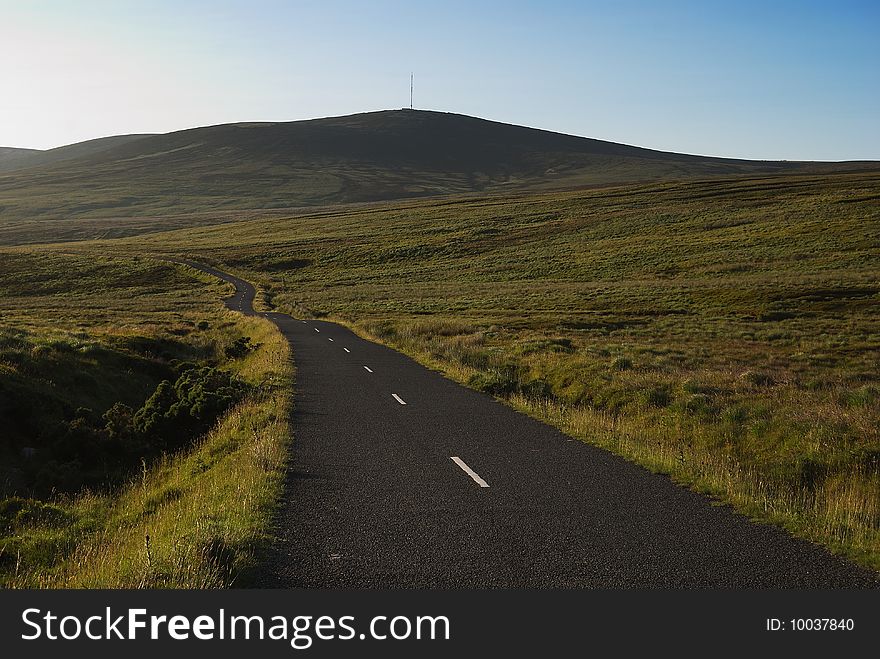 Narrow mountain road in Wicklow before sunset (Ireland)