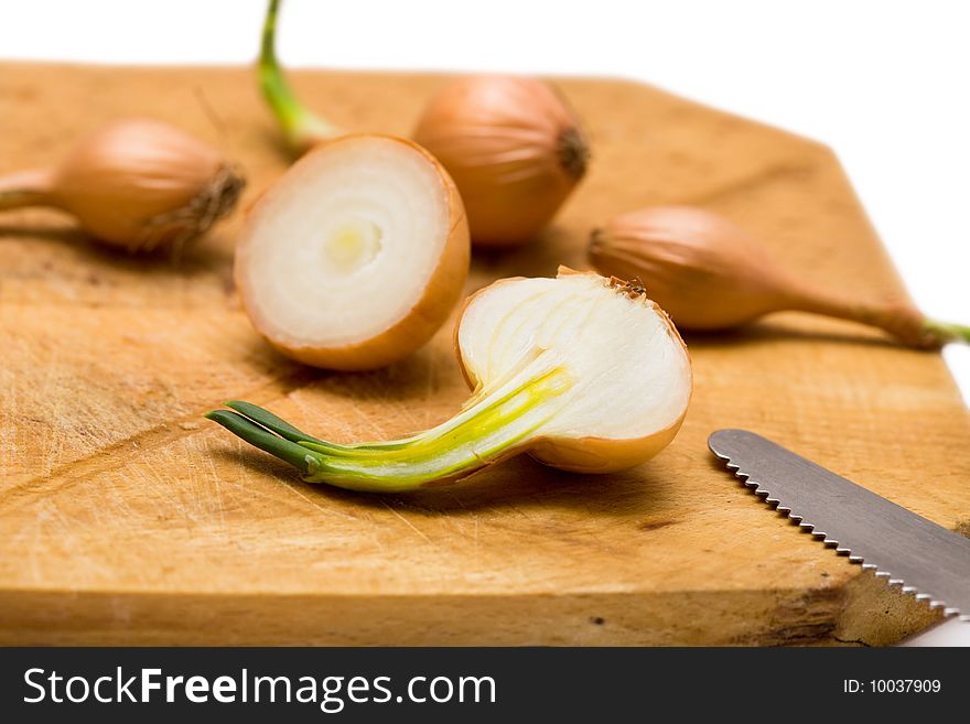 Onions on wooden board with knife
