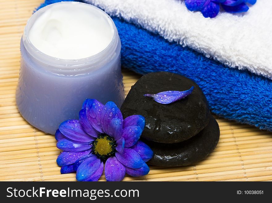 Cream, stones and towel with flowers