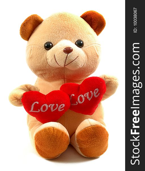 Teddy bear holding two hearts, isolated on white background.