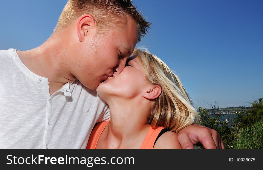 Young couple kissing in the sun. Young couple kissing in the sun