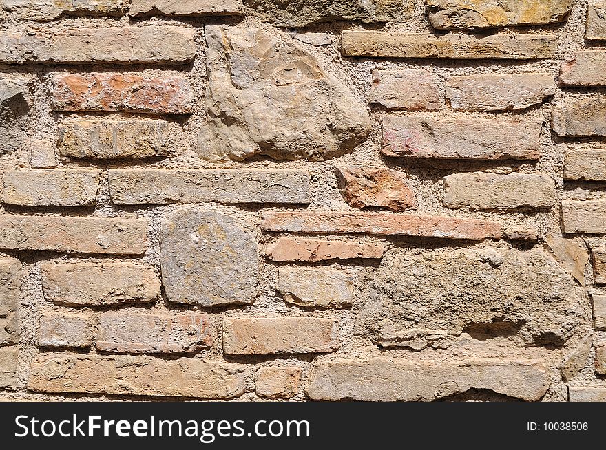 Rough medieval wall with bricks and stones. Rough medieval wall with bricks and stones.