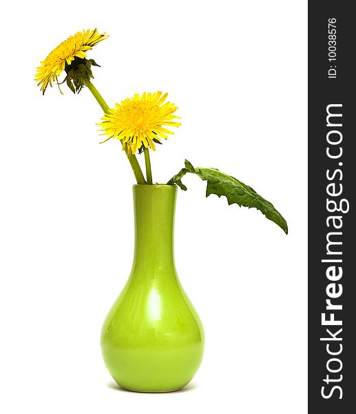 Dandelions are in a green vase