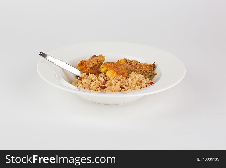 Chili rellenos and rice meal in a dish; isolated. Chili rellenos and rice meal in a dish; isolated.