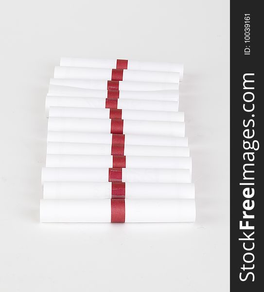 Row of little rolled private notes; isolated on a white background. Row of little rolled private notes; isolated on a white background.