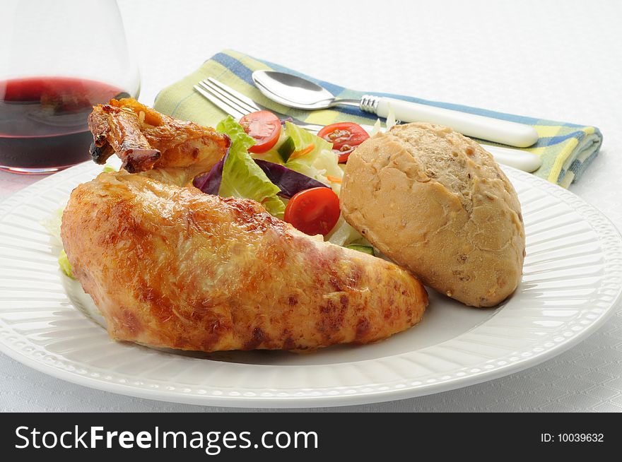 Barbecued chicken with salad and crusty roll. Barbecued chicken with salad and crusty roll.