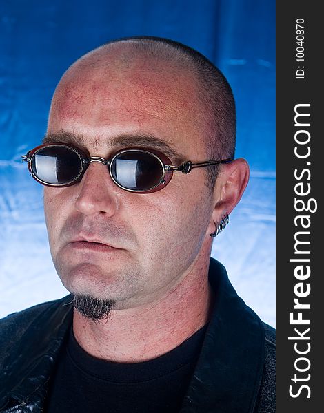 Portrait of trendy male model wearing sunglasses