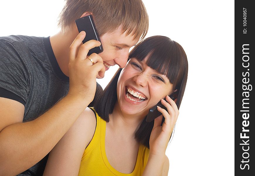 The young couple call by a mobile phone. The young couple call by a mobile phone