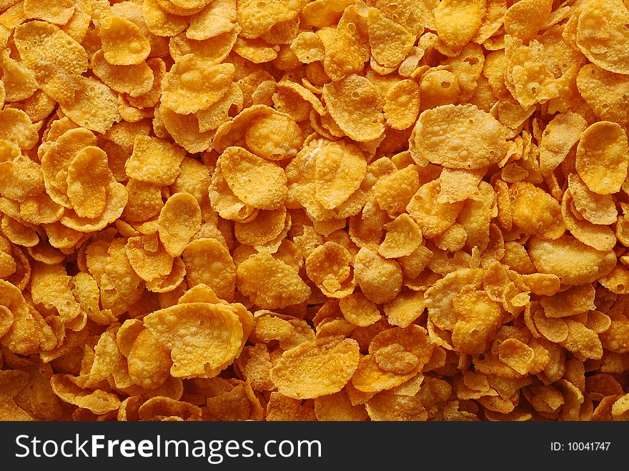 Background of many crispy cornflakes. Background of many crispy cornflakes