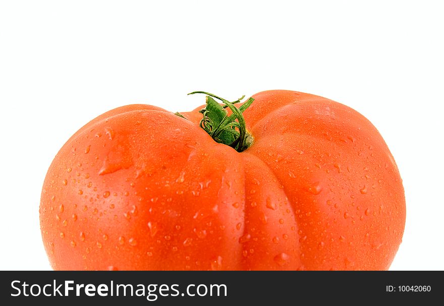 Ripe tomato on a white background. Close-up. Macro.