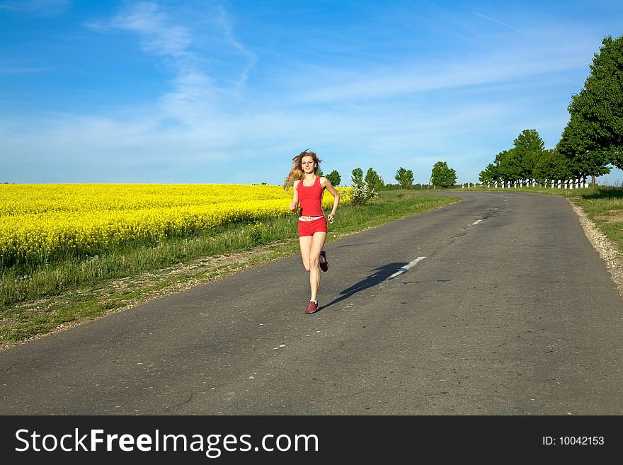 An image of a girl running on the road. An image of a girl running on the road