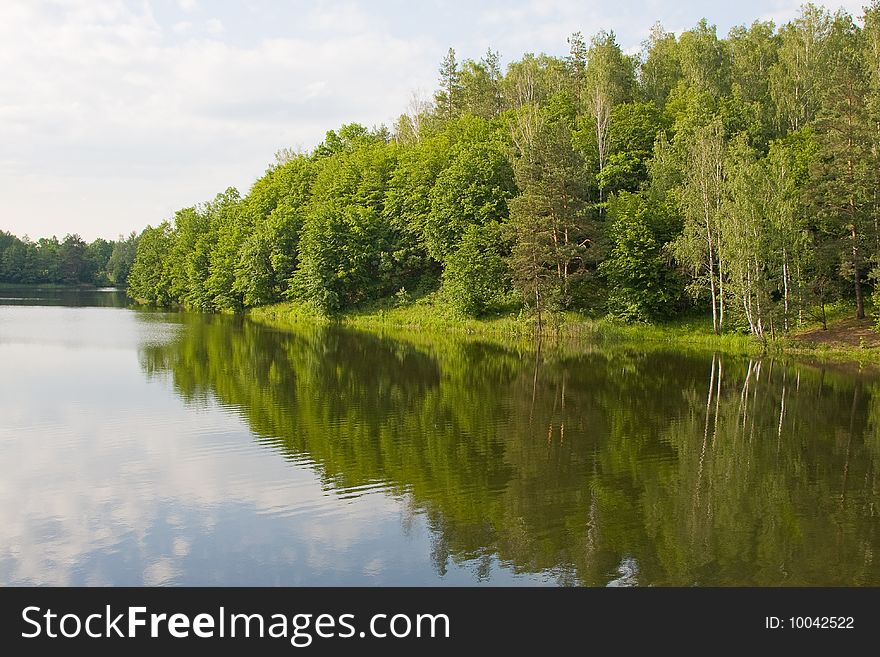 Picturesque landscape spring river and bright trees and bushes, against the backdrop of skies. Picturesque landscape spring river and bright trees and bushes, against the backdrop of skies.