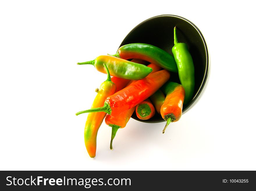 Chillis Spilling Out Of A Black Bowl