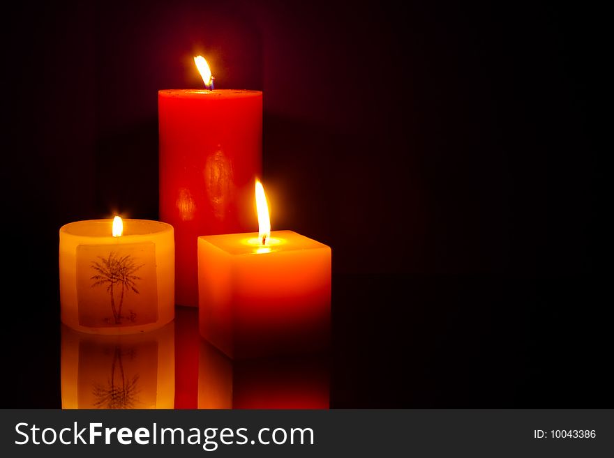 Three candles on blue background