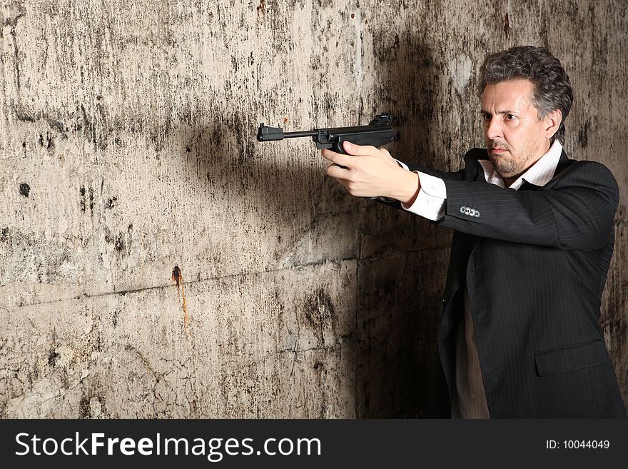 Man killer with gun on dark background