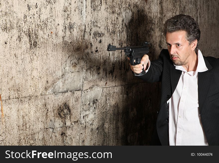 Man killer  with gun on dark background