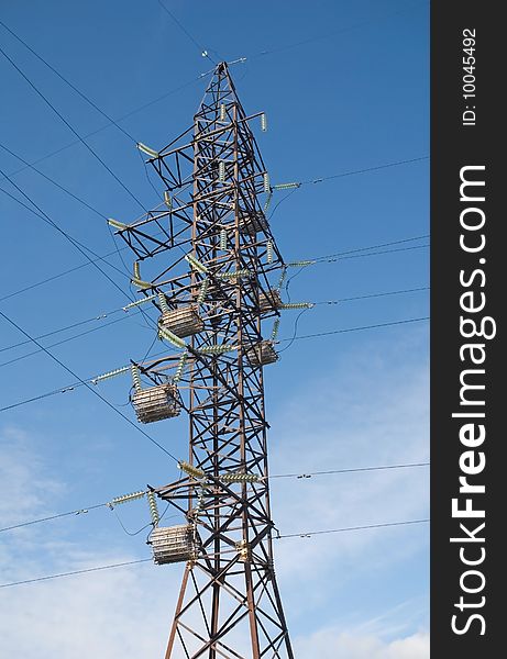 High-voltage post on a background blue sky