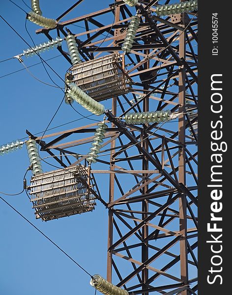 High-voltage post on a background blue sky