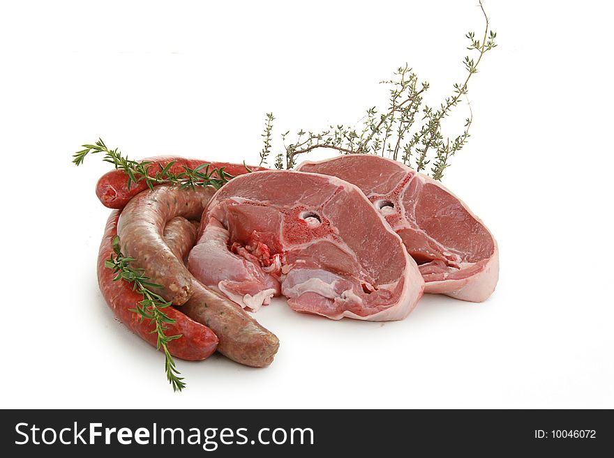 Lamb chop and sausages isolated on white background