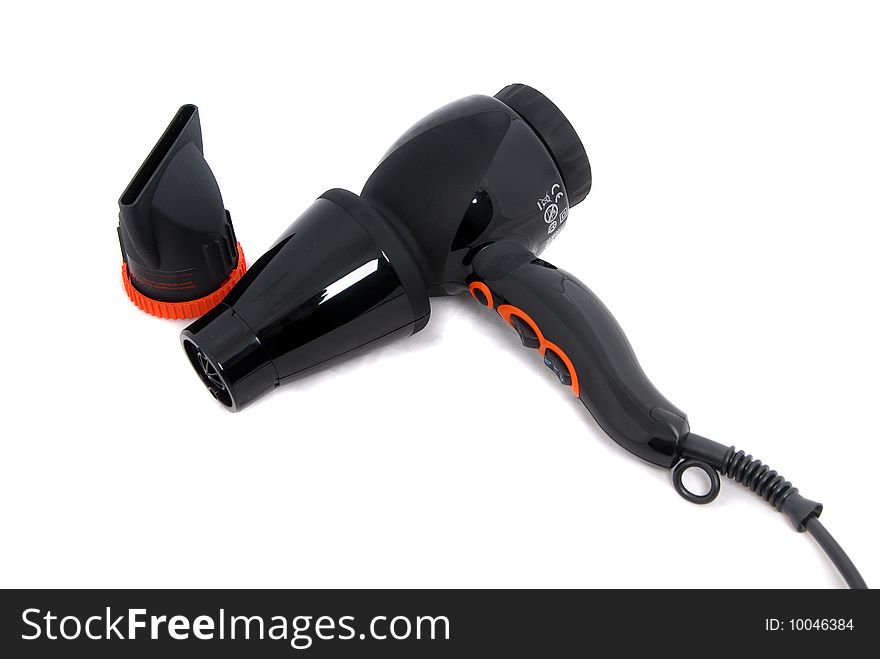 Professional hair dryer in black with a nozzle on a light background. Professional hair dryer in black with a nozzle on a light background